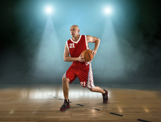 Caucassian Basketball Player in dynamic action with ball in a pr