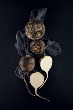 fresh black radish decorated on slate plate kitchen table can be used as background