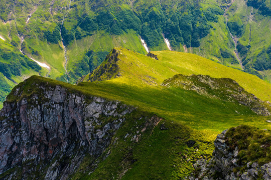 Fagaras mountains grassy slopes and rocky cliffs. beautiful nature background