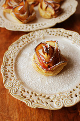 Tasty puff pastry with apple shaped roses on plate