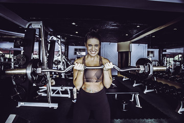 Fototapeta na wymiar Cute Young Woman Working Out at Gym 