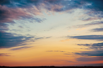 Interesting landscape sunset sky. Blue clouds diverge before the red sky. Fascinating moment.