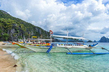 Bangka boats on the beatiful beaach in EL Nido bay, Philippines