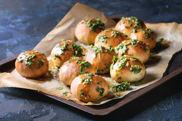 Traditional ukrainian homemade garlic buns pampushki for borscht soup with oil and coriander on old...