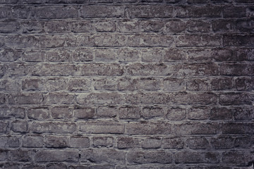 The wall is made of brown bricks.