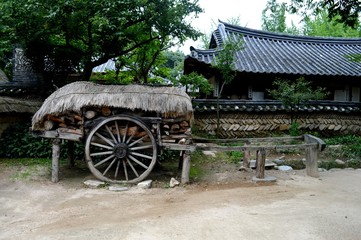 Fototapeta na wymiar A unique photo from the Korean village. Village home. A cart near the house.