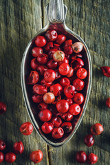 Pink pepper in a spoon