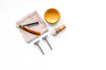 Tools beard and moustaches' care. Razor and brush on white background top view copyspace