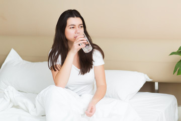 Young woman drink a glass of water at morning, healthy lifestyle concept