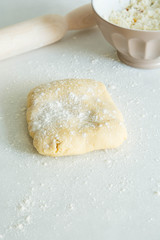 Cookie Dough Rolled out with Rolling Pin on a white Background.