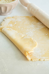 Cookie Dough Rolled out with Rolling Pin on a white Background.