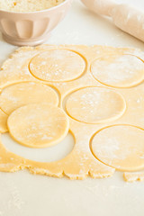 Cookie Dough Rolled out with Rolling Pin on a white Background.