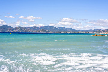 View from seashore to blue sea and mountains of Cannes resort in France