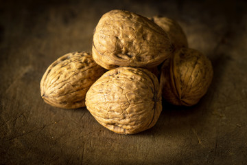 Whole walnuts on wooden table