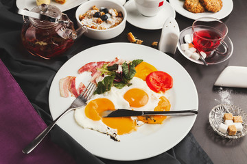 Restaurant breakfast with bacon and fried eggs
