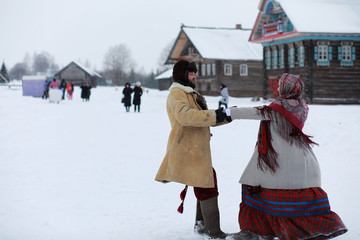 Couple in traditional winter costume of peasant in russia