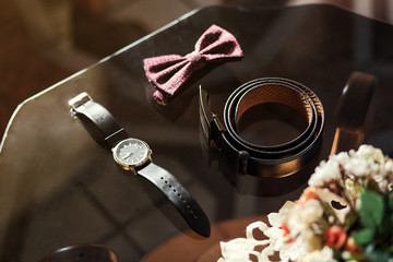 different accessories of a businessman for creating a style of a people lie on a wooden background