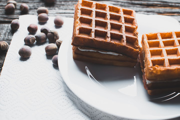 Waffle on a wooden background on a white napkin