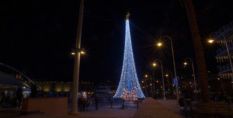GENOA (GENOVA), ITALY, DECEMBER 28, 2017 - Illuminated Christmas tree in the old harbor (porto antico) of Genoa, Italy.