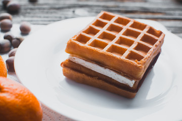 Waffle on a wooden background on a white napkin
