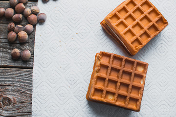 Waffle on a wooden background on a white napkin