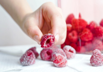take raspberries by hand © Nataliia Makarovska