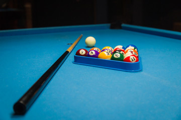 Billiard pool balls in triangle and stick on table