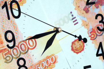 Time is money concept. Large wall clock with a financial background.