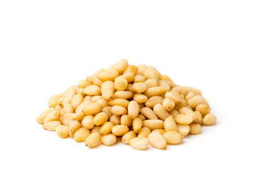 Heap of pine nuts on a white, closeup.