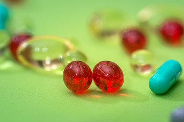 many different pills isolated on green background