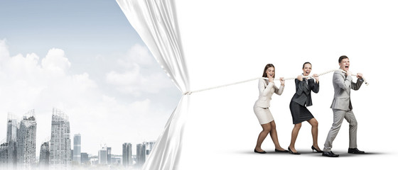 Young businesspeople working in collaboration and pulling white advertisement banner