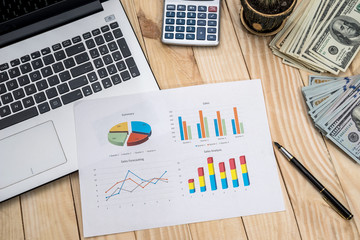 Office workplace - business chart, laptop, pen, dollar and calculator