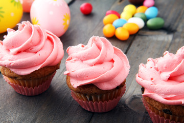 Tasty cupcakes on wooden background. Birthday cupcake in pink color