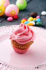 Tasty cupcakes on wooden background. Birthday cupcake in pink color