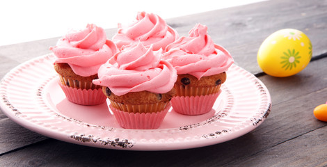 Tasty cupcakes on wooden background. Birthday cupcake in pink color