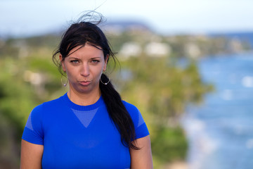 Fototapeta premium Young woman pulling faces pouting at the camera