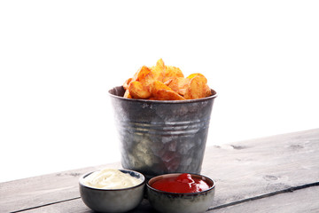 French fries potato with ketchup and mayonnaise on wooden background