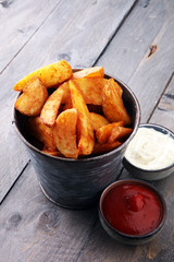 French fries potato with ketchup and mayonnaise on wooden background