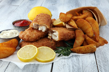 traditional British fish and chips with potato and lemon