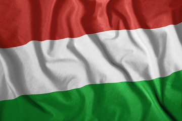 The Hungarian flag flutters in the wind. Colorful, national flag of Hungary. Patriotism.