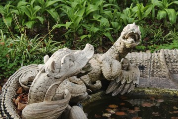 Stone figures in garden fountain