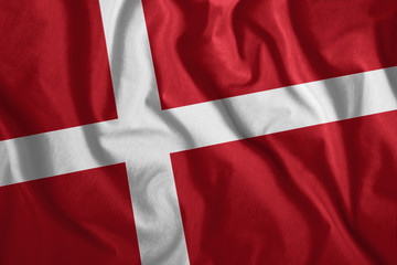 Fototapeta premium The Danish flag flutters in the wind. Colorful, national flag of Denmark. Patriotism, a patriotic symbol.
