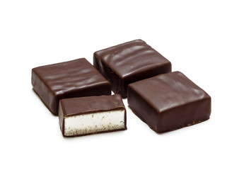 Four chocolate candies isolated on white background, bird's milk
