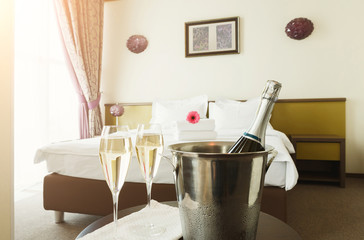 Two glasses and bottle of champagne in hotel