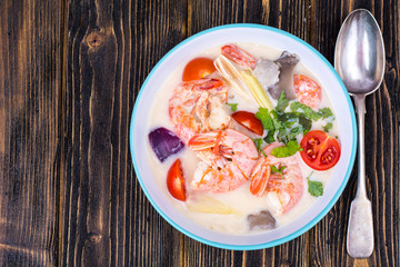 Delicious hot Thai soup Tom Yam with coconut milk and shrimps