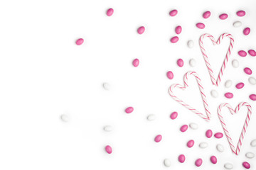 Pink and White candies and lollipops Top view White Background Valentine's Day