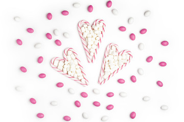 Pink and White candies and lollipops Top view White Background Valentine's Day