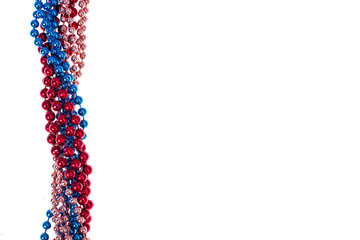 Multi colored shiny mardi gras beads on white background © ArtCookStudio