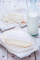 Homemade cheese Camembert and Brie on a gray wooden background