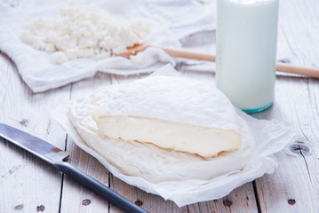 Homemade cheese Camembert and Brie on a gray wooden background